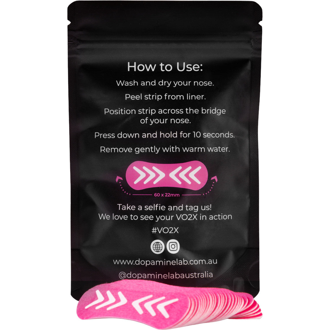 A black resealable pouch with white text showing how to use a pink and white nose strip, with several pink and white strips stacked in front on a white background.